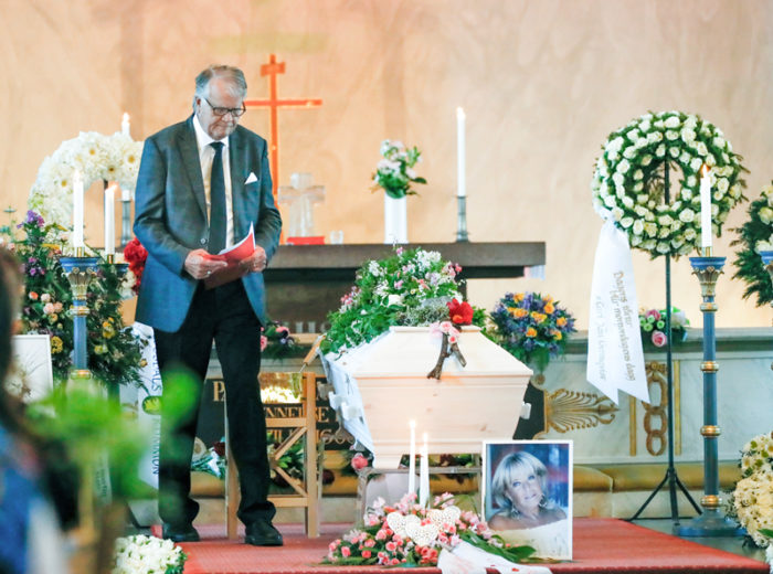 Lasse Berghagen står vid kistan vid Barbro